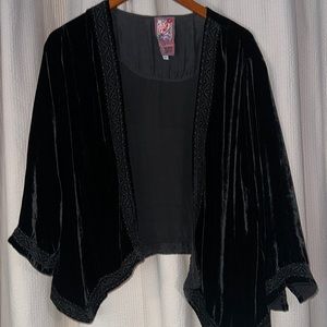 Velveteen jacket with embroidered detail along edge and cuffs.